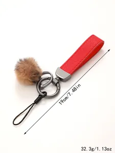 Detailansicht eines roten Leder-Schlüsselanhängers mit Plüschbommel und Maßen