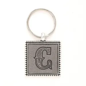 Decorative silver alloy keychain with embossed leather insert featuring the initial letter C