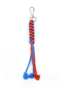 Macro view of hand-woven corn knot paracord keychain in vibrant blue and orange dual colors.