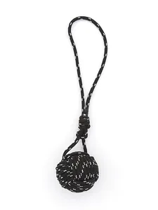 Close-up of a hand-woven black polyester monkey fist knot keychain charm for bags