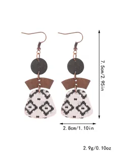 Close-up detail of bohemian geometric cork earrings featuring multi-layered Aztec patterns