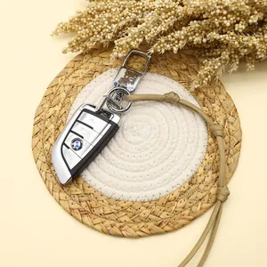 Close-up of handmade braided paracord keychain on a woven mat for car keys