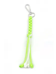 Detailed view of handmade neon green and white corn knot braided paracord keychain