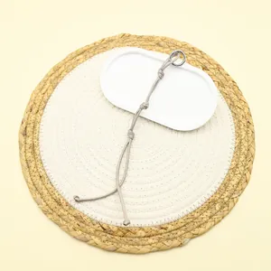 Close-up detail of handmade woven polyester rope keychain charm with silver metal ring