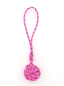 Macro view of handmade pink polyester braided monkey's fist knot pendant for DIY crafts
