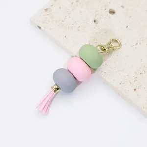 Detail view of macaron pastel keychain featuring acrylic beads and a soft pink tassel