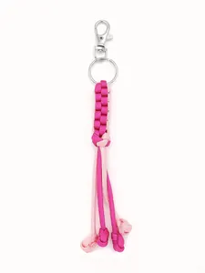 Detailed macro view of handmade pink contrast paracord keychain with corn knot design