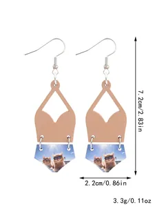 Macro view of bohemian cork earrings with cat print showing dimensions and weight