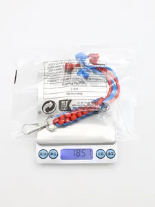 Detailed view of the bicolor braided paracord keychain on a digital scale weighing 18.51g.
