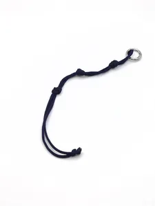 Detail of handmade dark blue braided polyester rope keychain with silver ring