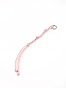 Close-up view of a pink handmade braided polyester rope keychain with a silver ring