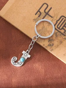 Detailed view of the letter J alloy keychain with turquoise inlay and Western carvings