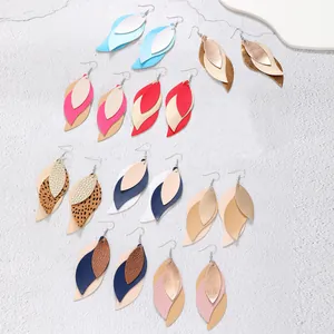 Various colors of multi-layered leaf-shaped PU leather earrings on white surface