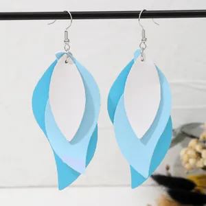 Close-up detail of stylish multi-layered PU leather leaf earrings in blue and white