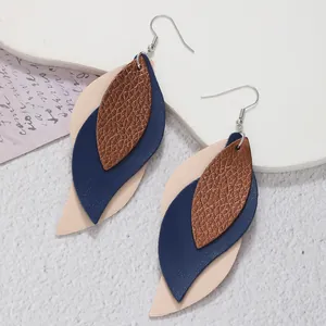 Close-up of minimalist S-shaped multi-layered PU leather leaf earrings for women