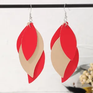Detail view of stylish red and beige multi-layer leaf earrings made of soft PU leather