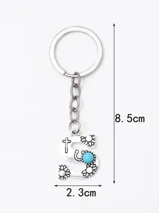 Detailed view of silver letter S keychain with turquoise stone and floral engravings