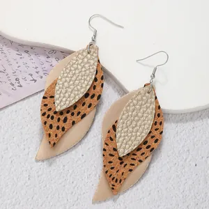 Detailed view of bohemian layered PU leaf earrings with leopard print and gold texture.
