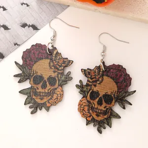 Close-up detail of Halloween wooden earrings with vintage skull and flower print.