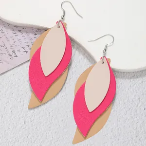 Detailed close-up of multi-layer leaf-shaped PU leather earrings in pink and beige.