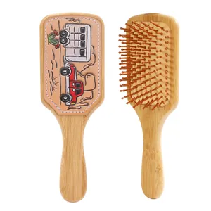 Detail view of retro Western cowboy style bamboo cushion hairbrushes with leather patch
