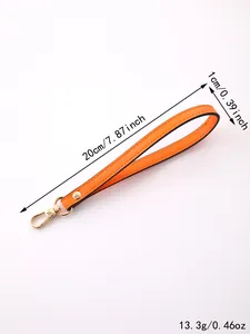 Detailed view of an orange leather wristlet strap showing 20cm length and 13.3g weight