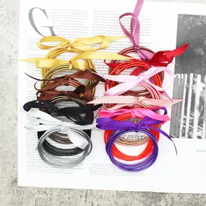 Stylish multi-colored gold foil jelly bangles set tied with elegant silk ribbon bows