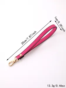 Detail view of pink PU leather wrist strap with gold-tone lobster clasp and size markings.