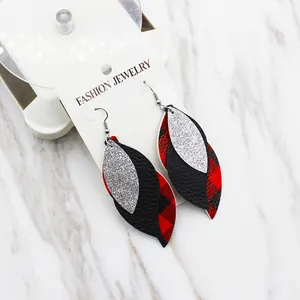 Detail view of S-shaped leaf multi-layer PU leather earrings with red plaid and silver glitter