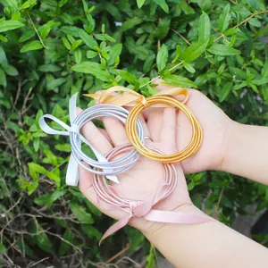Set of gold leaf filled jelly bangles with elegant silk ribbon bows for women