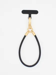 Detailed view of a premium minimalist black PU leather phone lanyard with gold metal clasp