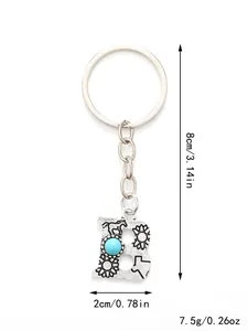 Detail view of an alloy letter B keychain with turquoise and size labels.