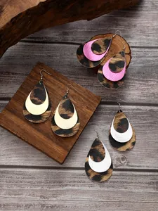 Macro view of multi-layered leopard print PU leather teardrop earrings in 3 colors.