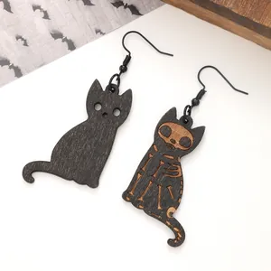 Halloween wooden cat earrings featuring black silhouette and carved skeleton design