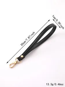 Detailed view of black faux leather wristlet strap with gold hardware and dimensions