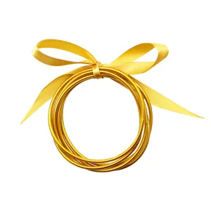 Elegant set of five gold foil jelly bangles tied with a yellow ribbon bow
