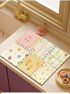 Close-up detail of a colorful cartoon absorbent drainage mat placed on a kitchen countertop