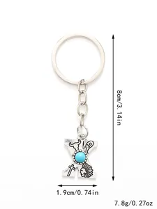 Vintage silver alloy letter X keychain with turquoise and western motifs, 8cm height.