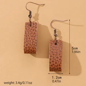 Detail view of textured brown PU leather drop earrings with precise dimensions and weight