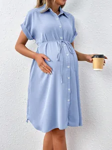 Side view of light blue short sleeve maternity shirt dress with adjustable waist tie