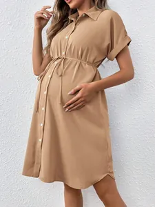Detailed view of khaki maternity shirt dress with buttons and adjustable waist tie