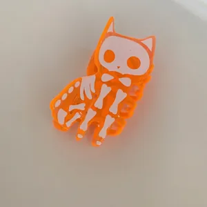 Detailansicht der orangefarbenen Halloween-Haarklammer aus Acryl mit Skelettkatze