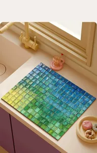 Detailed view of the vibrant mosaic pattern on an absorbent kitchen countertop mat.