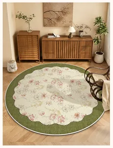 Round floral area rug with green scalloped border in a cozy mid-century room setting