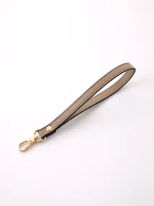 Close-up of elegant khaki PU leather wristlet strap featuring a gold-tone metal lobster clasp