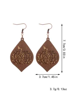 Detail view of Halloween wooden teardrop earrings with pumpkin and leopard print