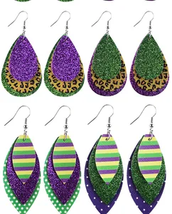 Detail view of Mardi Gras themed three-layer leather earrings with glitter and festive patterns