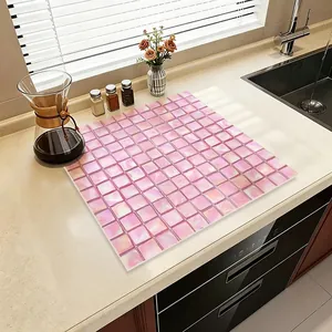 Stylish pink mosaic absorbent leather kitchen mat placed on a modern countertop near a sink