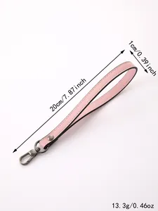 Detail view of the pink leather wrist strap accessory showing length width and weight