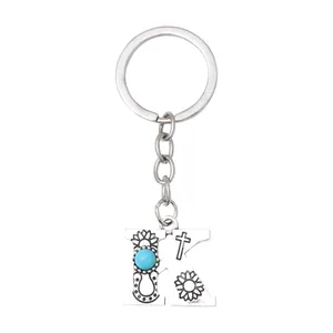 Vintage silver alloy letter K keychain with turquoise stone and floral patterns.